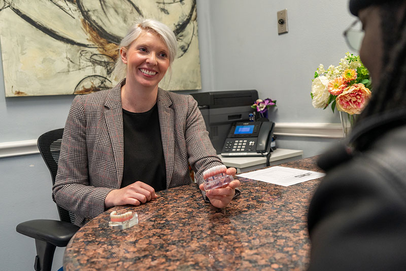 staff member going over dental options with patient within the dental center