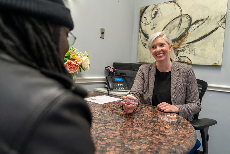 staff member helping patient with dental options and planning