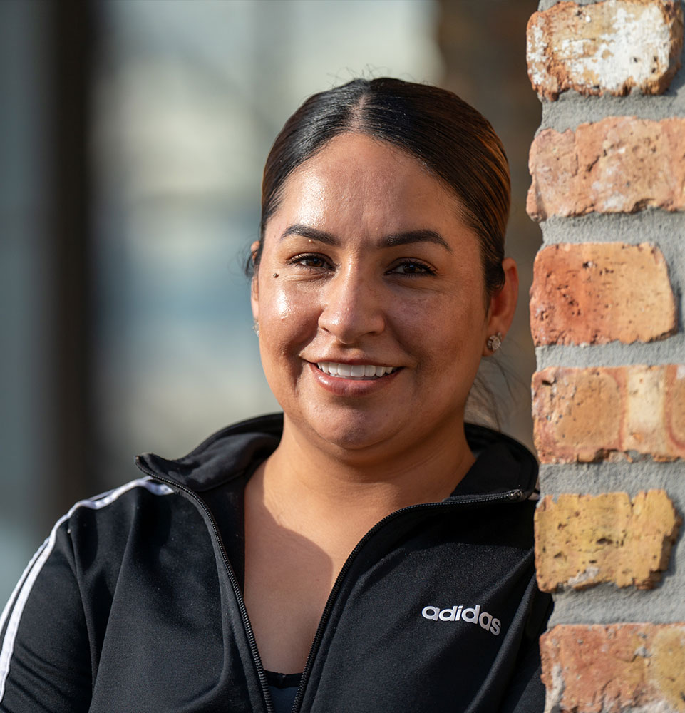 patient smiling brightly while being outside of the dental center